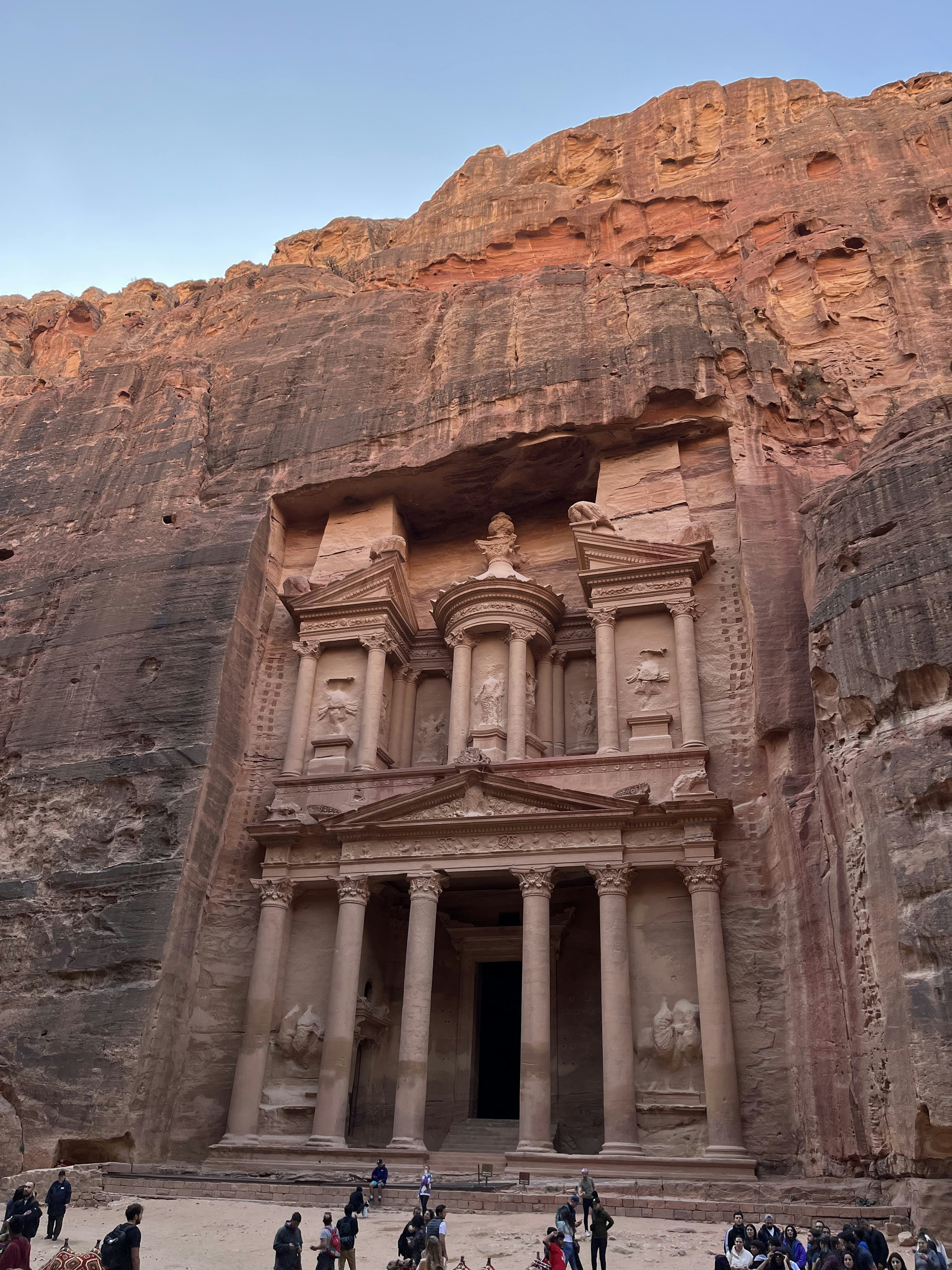 The Treasury monument carved into rose-red sandstone cliffs in Petra Jordan