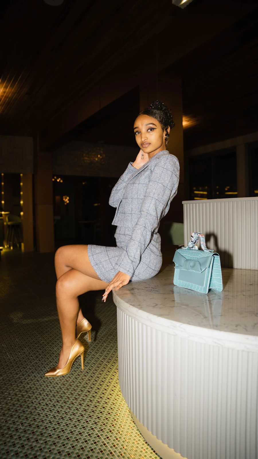 Black woman in an elegant hotel lounge reviewing notes