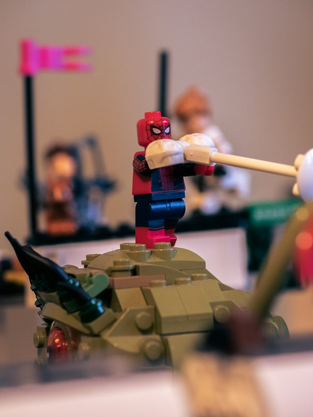 a lego man hitting a ball with a bat