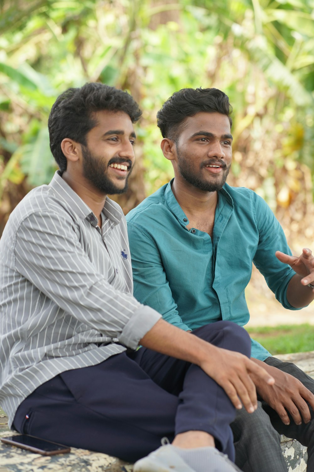 a couple of men sitting next to each other