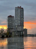 Sunset view of a completed pre-development project with modern buildings and landscaping.
