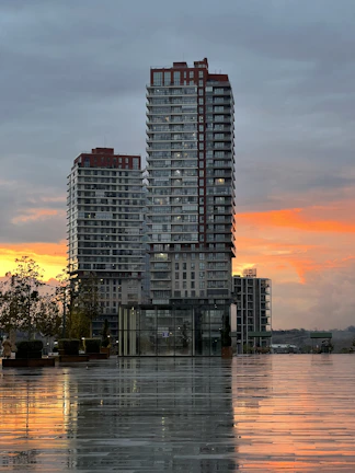 Sunset view of a completed pre-development project with modern buildings and landscaping.