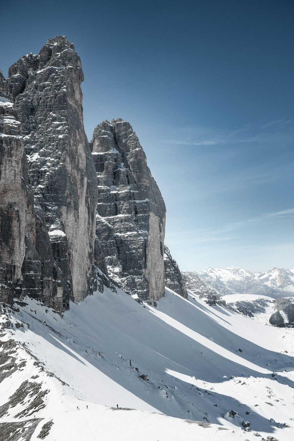 a snow covered mountain with a very tall rock formation