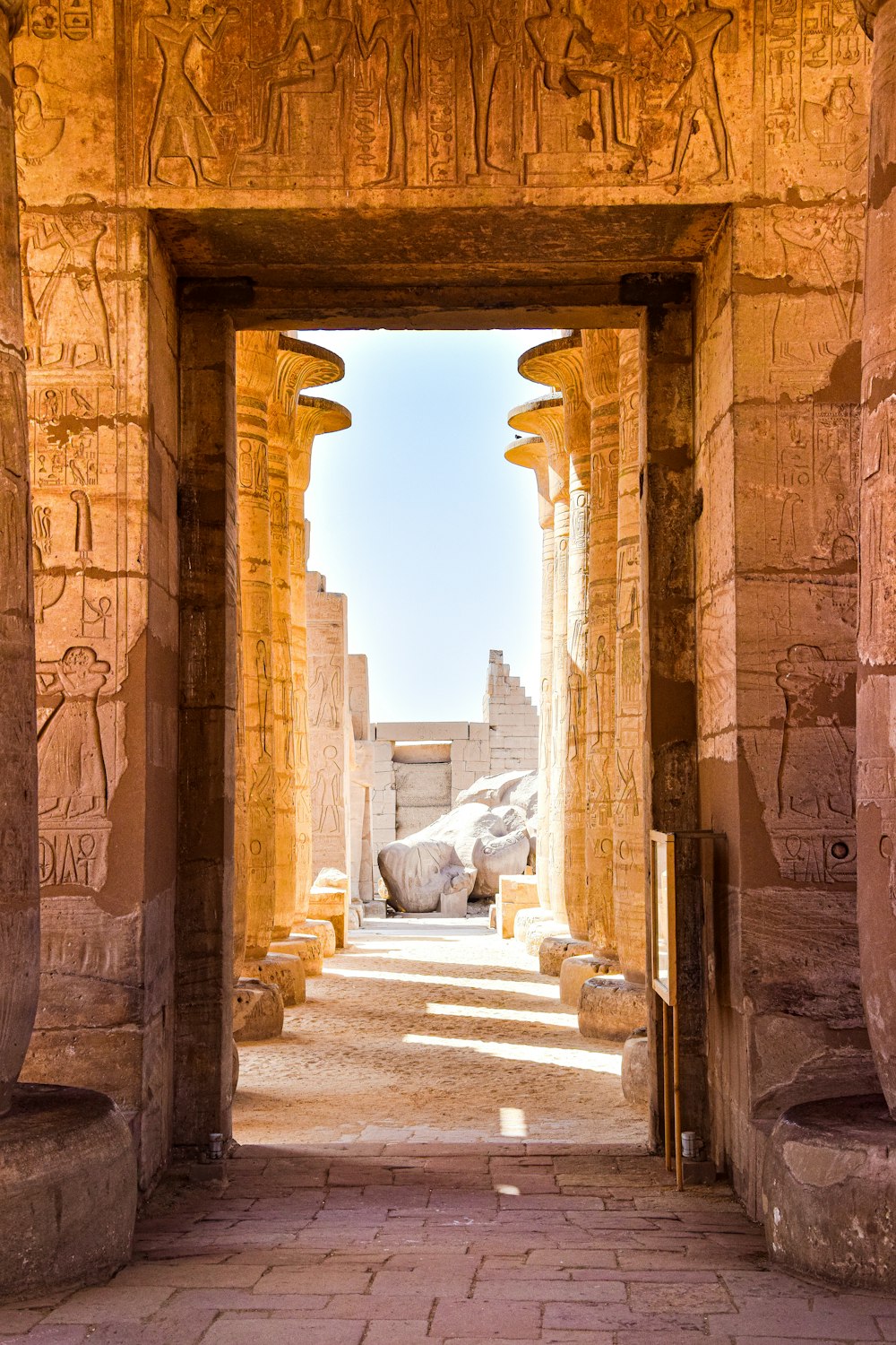 an archway leading to a building with statues on it