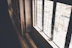 Close-up photo of newly installed wooden window frame in a cozy living room.