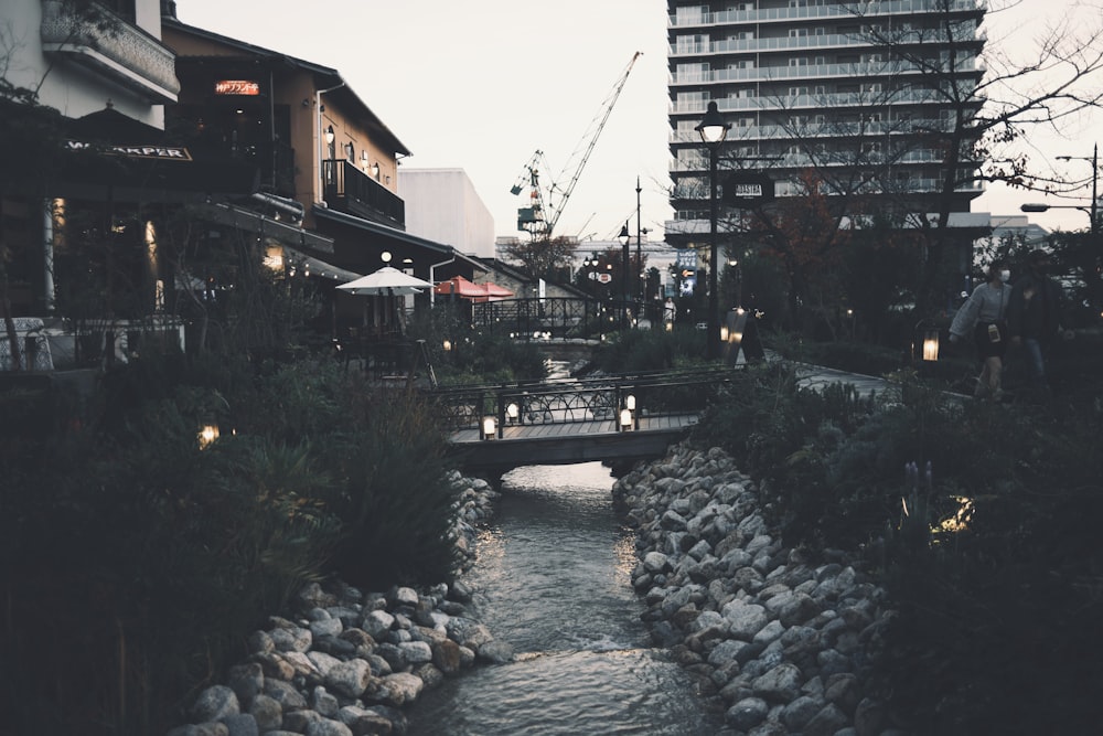 a river running through a city next to tall buildings