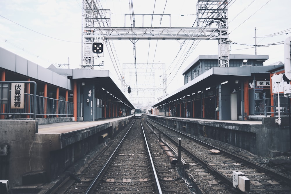 a train station with a train on the tracks