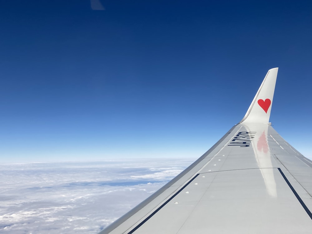 the wing of an airplane with a heart painted on it