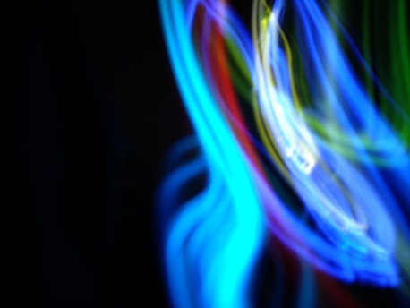 Colorful animated graphics flowing across a screen, illustrating creativity and movement.