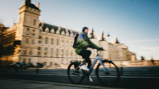 A cityscape blurred in motion behind a rider wearing a Lumina helmet, capturing the spirit of active urban life.