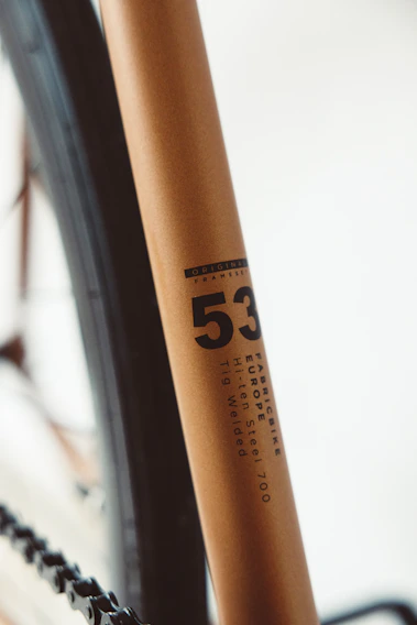 Close-up of a heavy welded steel frame with precise welds and a matte navy finish, highlighting craftsmanship.