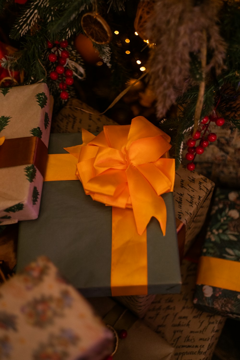 a group of wrapped presents under a christmas tree