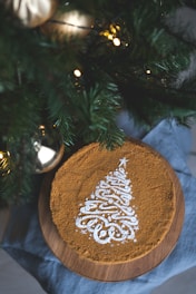 A close-up of a glittering Christmas cake decorated with sparkling sugar crystals and festive ornaments.