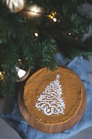 A close-up of a glittering Christmas cake decorated with sparkling sugar crystals and festive ornaments.