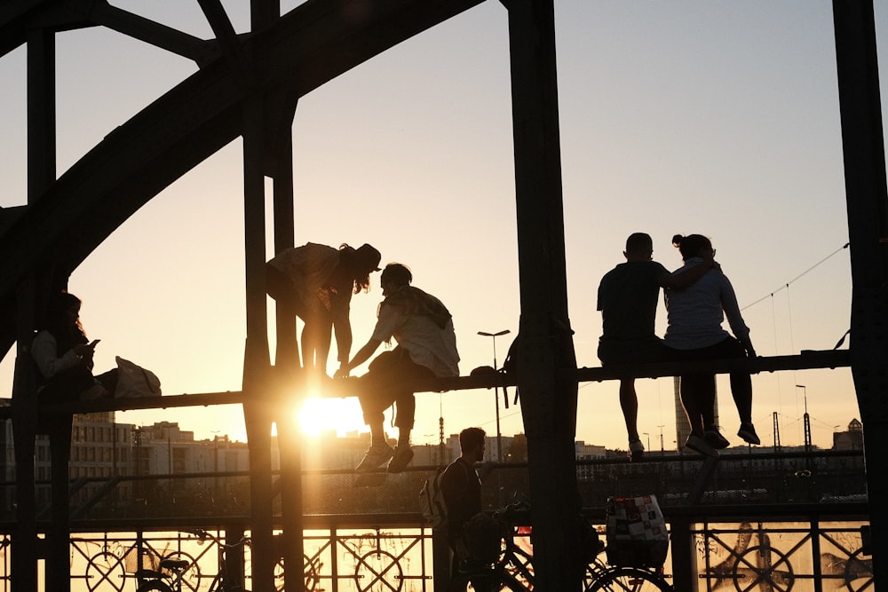 a group of people standing on top of a bridge