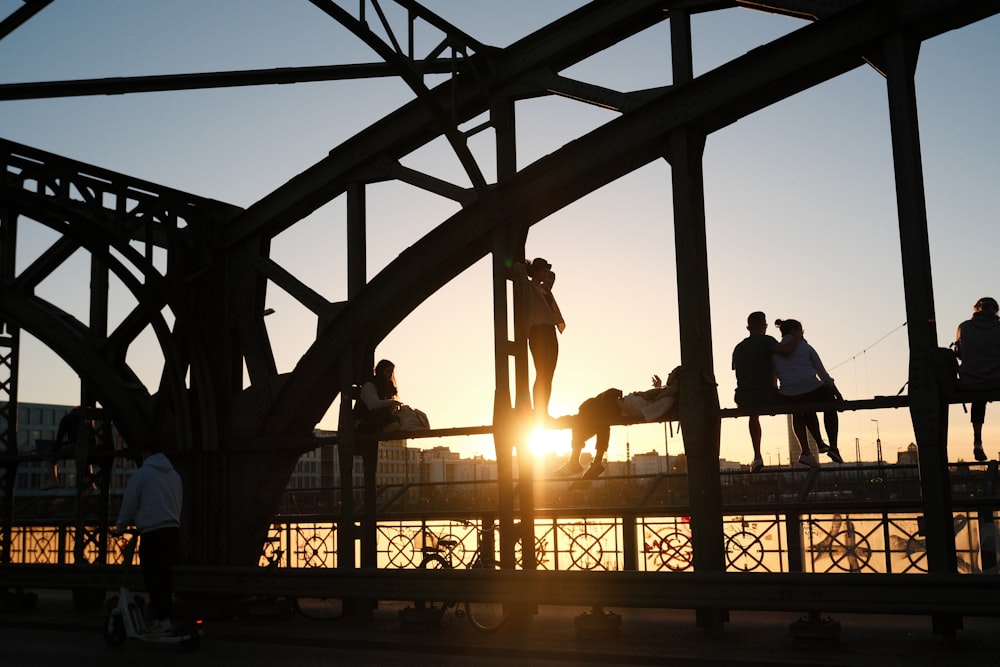 a group of people standing on top of a bridge