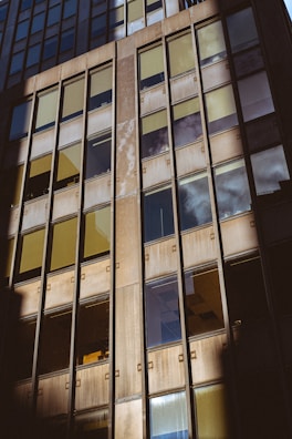 Exterior of a commercial building with freshly washed windows reflecting the sky.