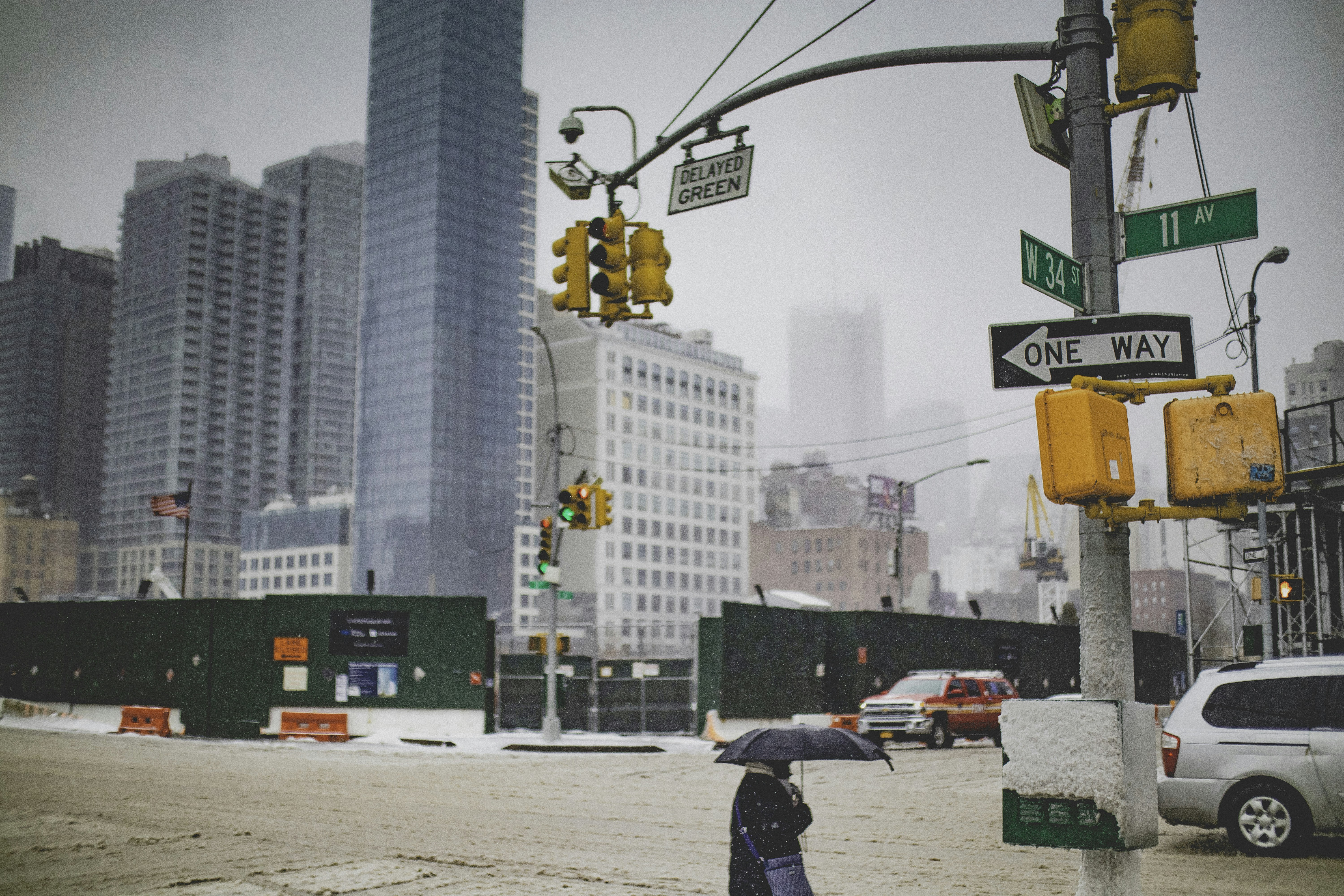 a person standing under an umbrella on a city street