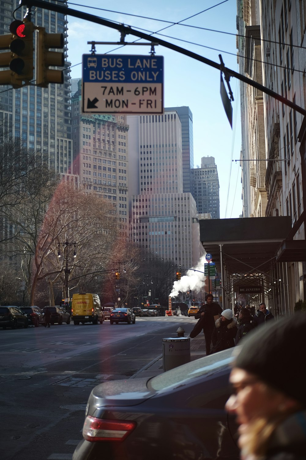 a busy city street with tall buildings and traffic lights