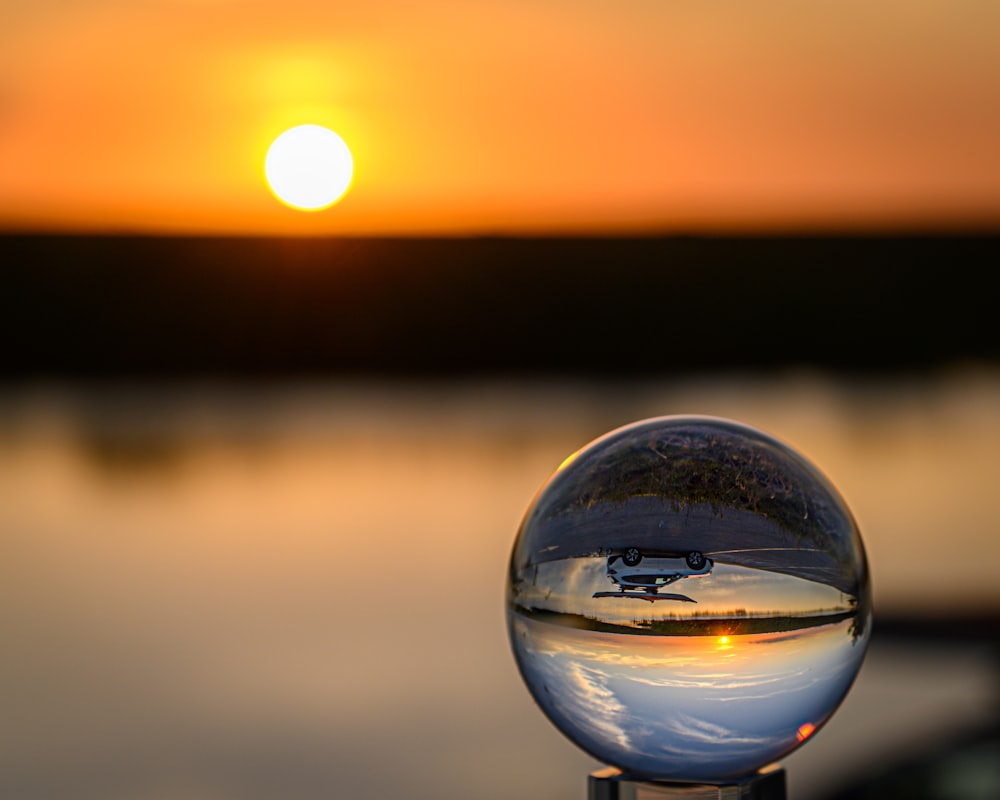 the sun is setting over a body of water