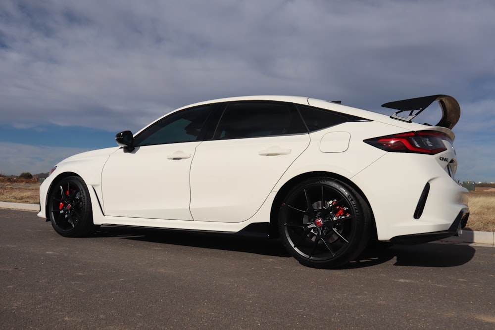 a white car parked on the side of the road