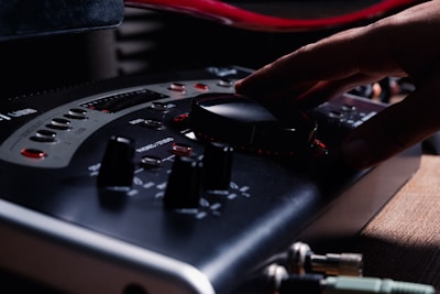 a hand is pressing buttons on a control panel