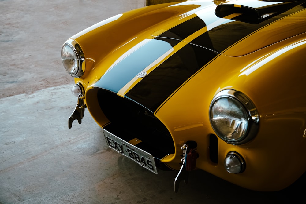 a close up of a yellow and black sports car