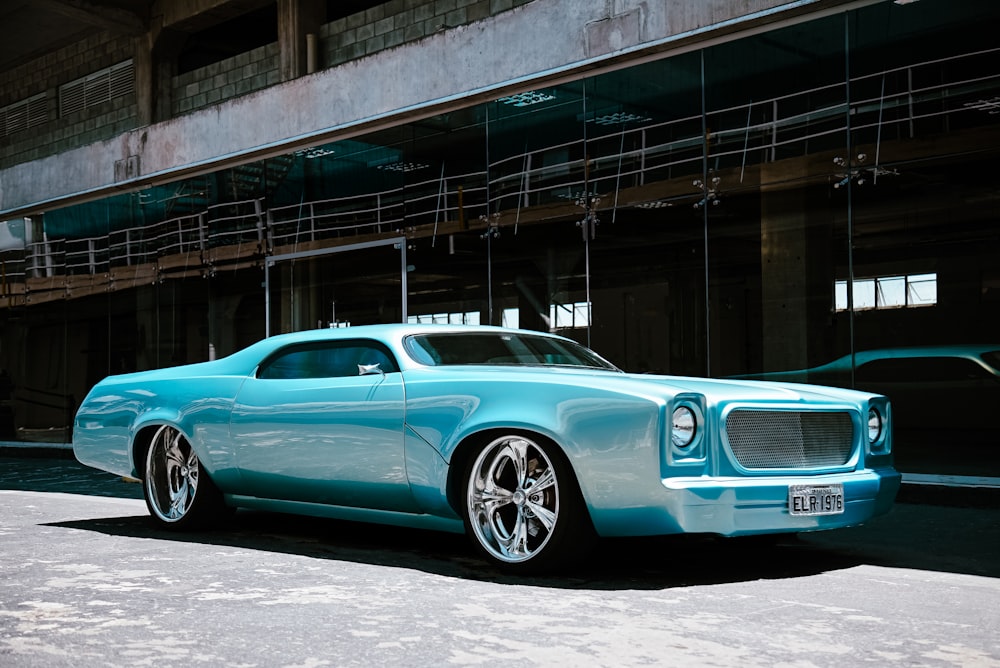 a blue car parked in front of a building