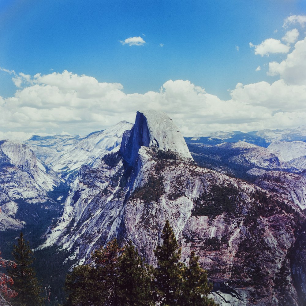 a view of the top of a mountain with a sky background