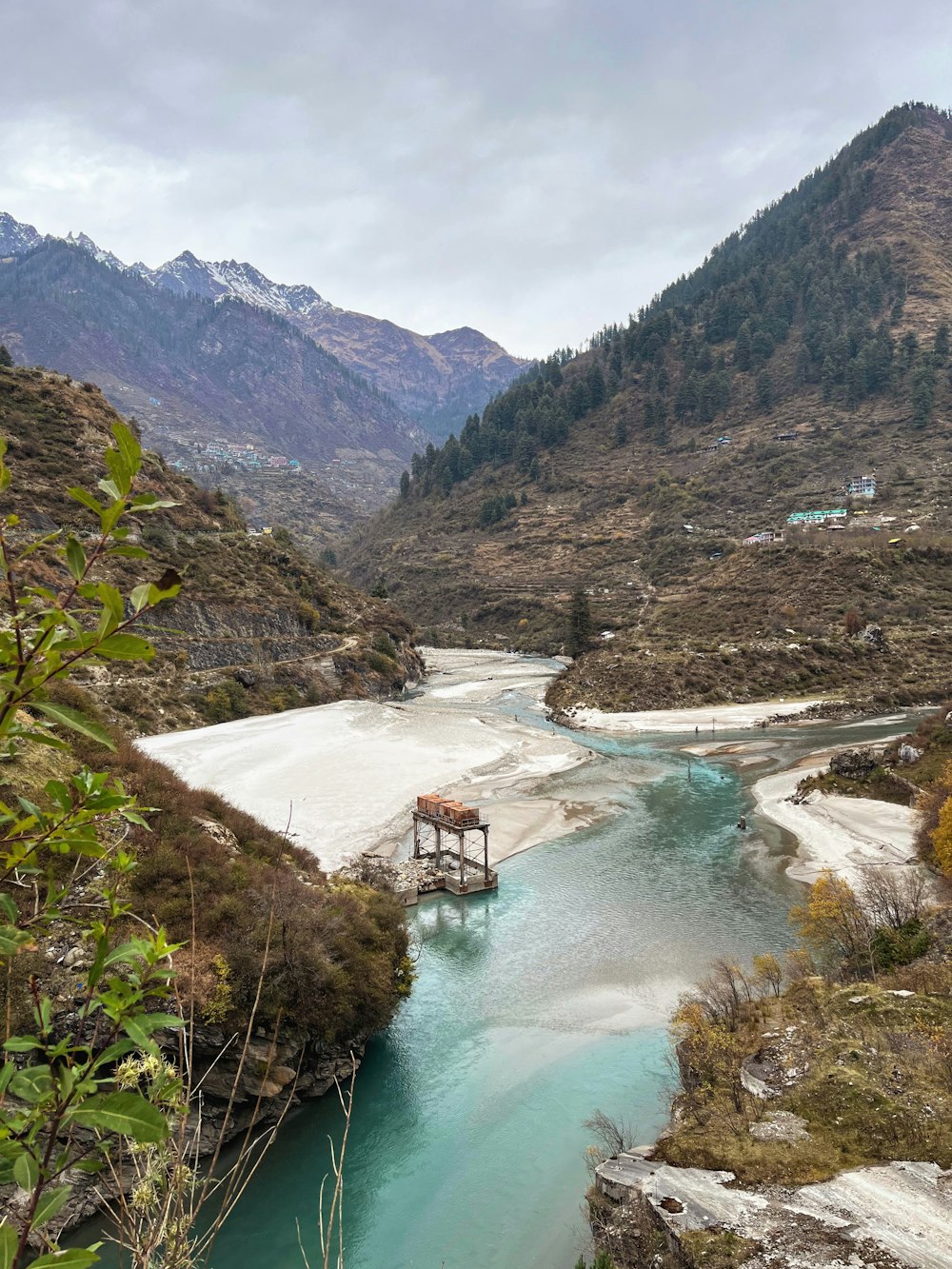 a river running through a valley surrounded by mountains