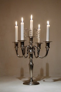 a silver candelabra with five lit candles