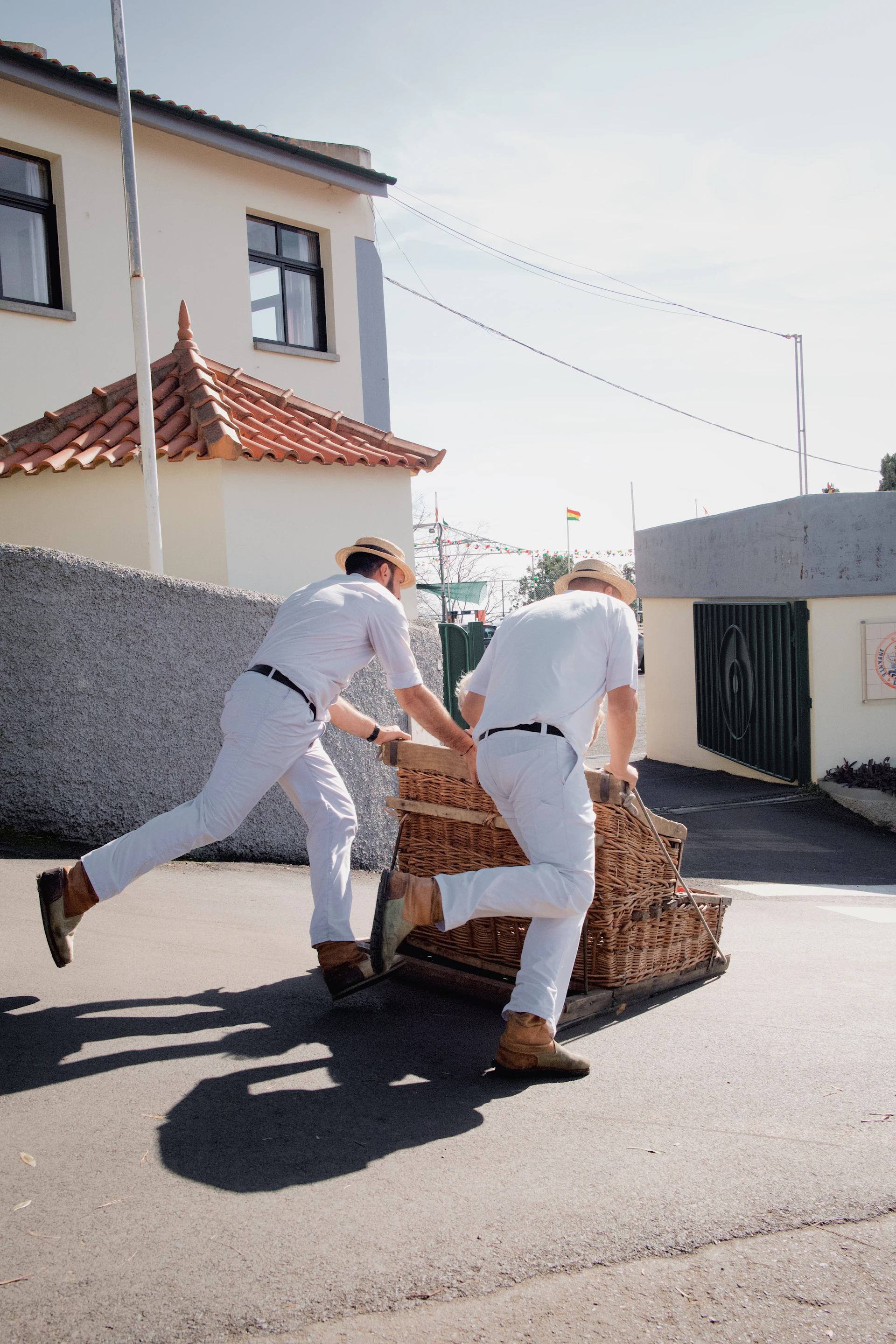 two men in white suits pushing a basket