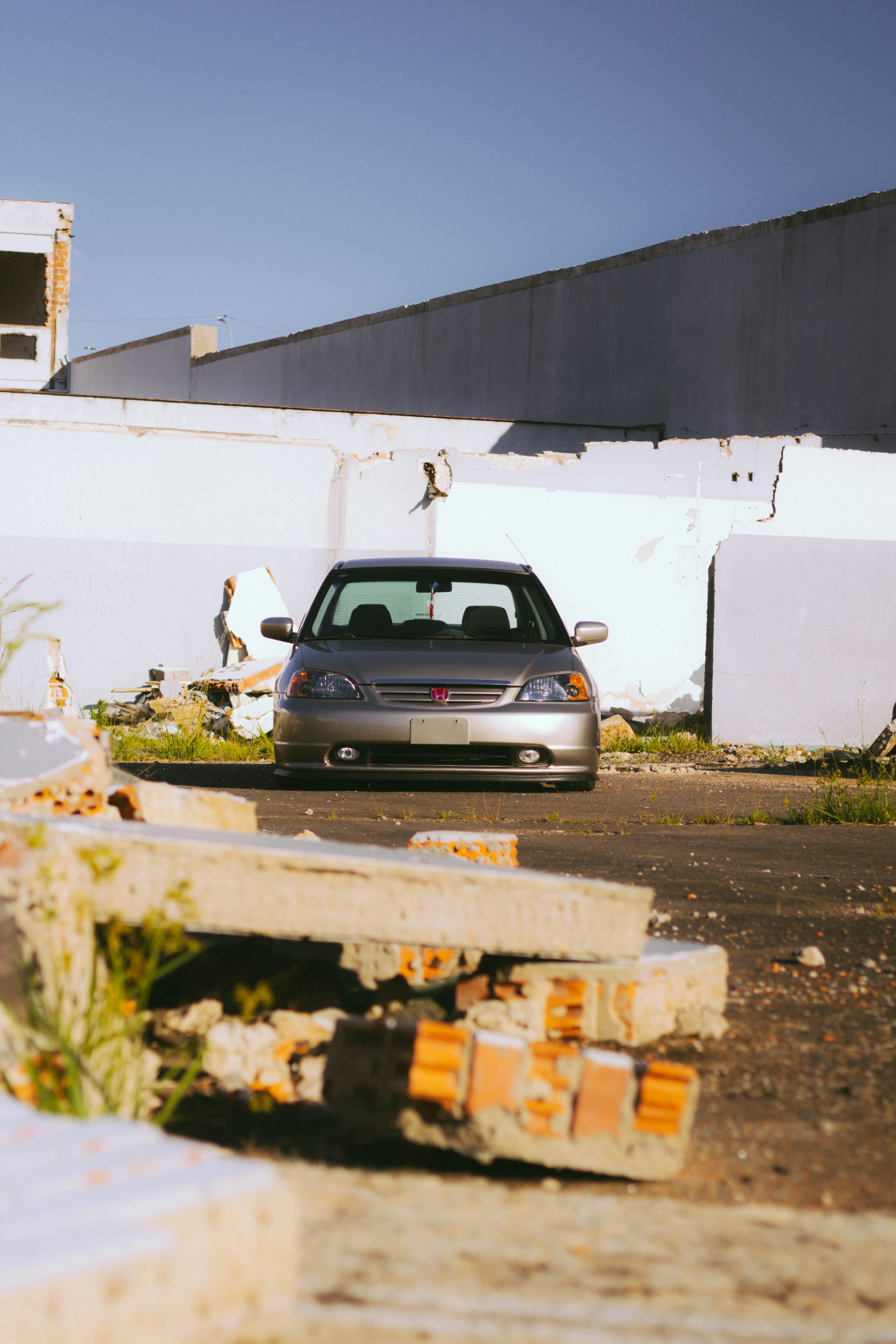 a car parked in a parking lot next to a building