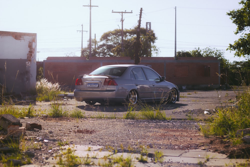 a car parked in a lot next to a building