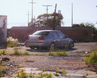 a car parked in a lot next to a building