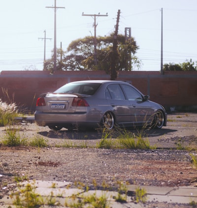 a car parked in a lot next to a building