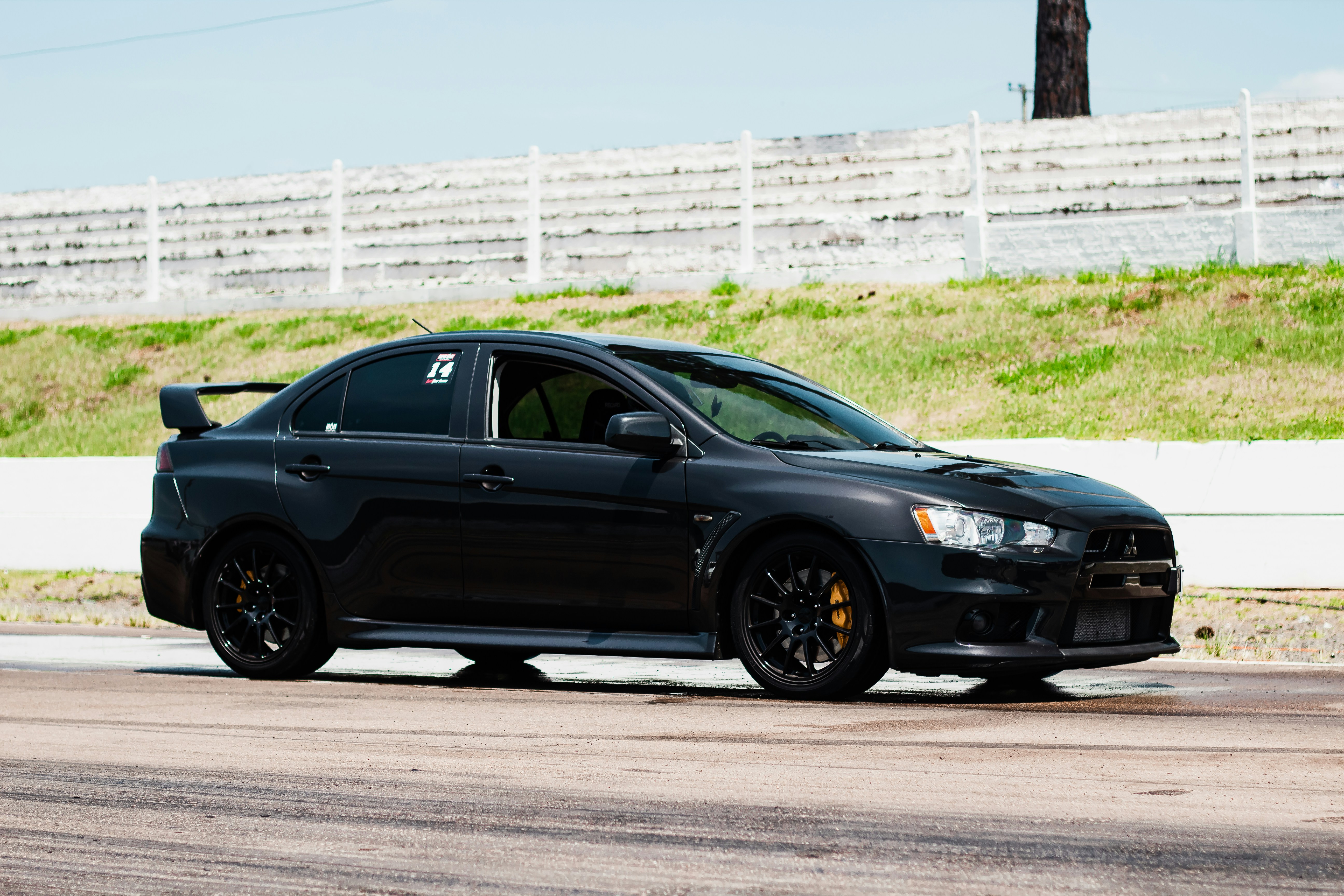a black car parked on the side of a road