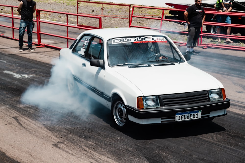 a white car with smoke coming out of it