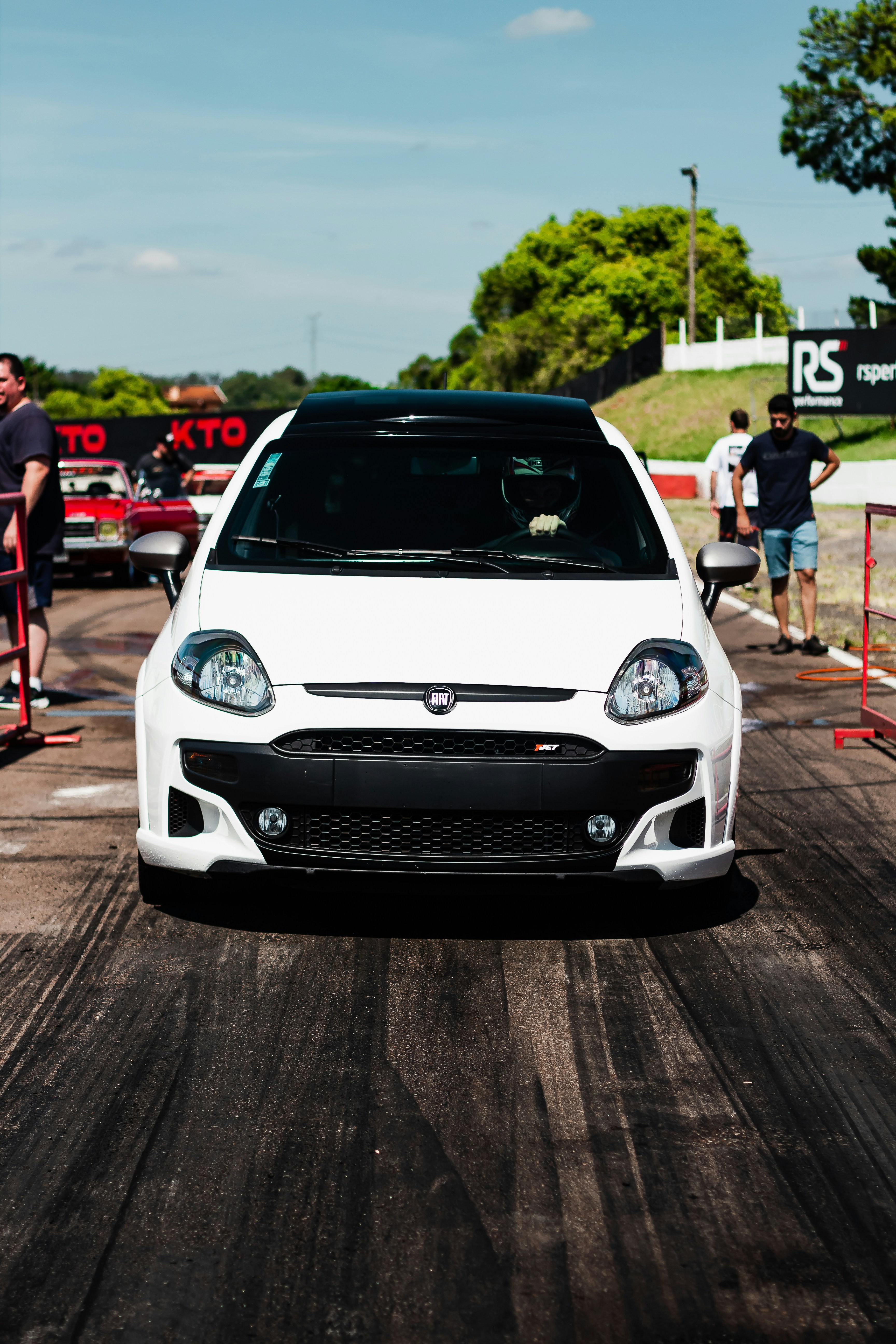 a white car driving down a race track
