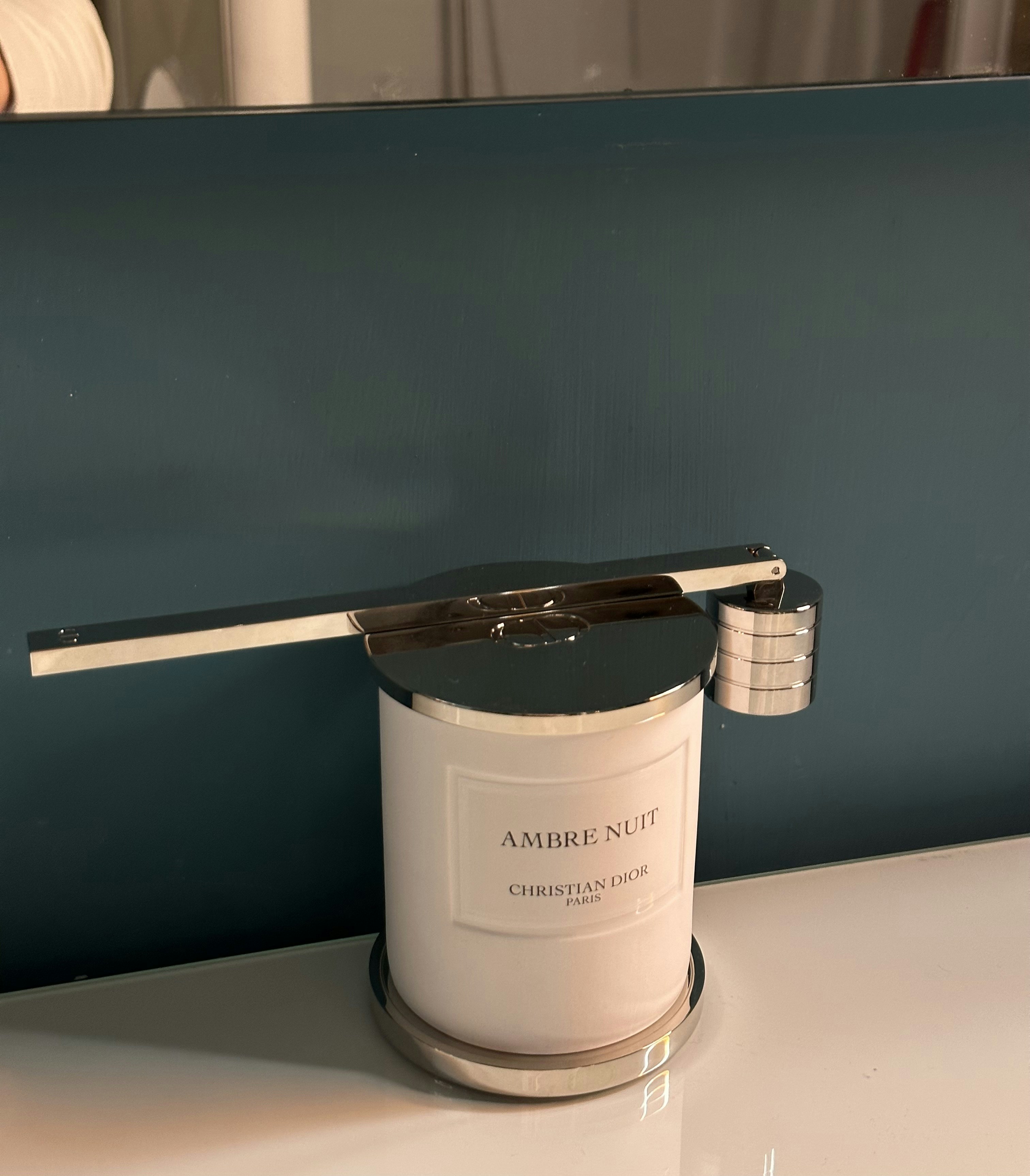 a white candle sitting on top of a table