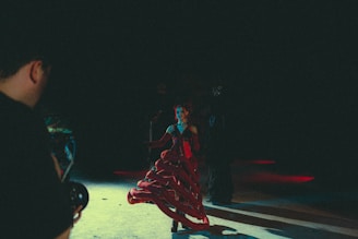a man standing next to a woman in a red dress