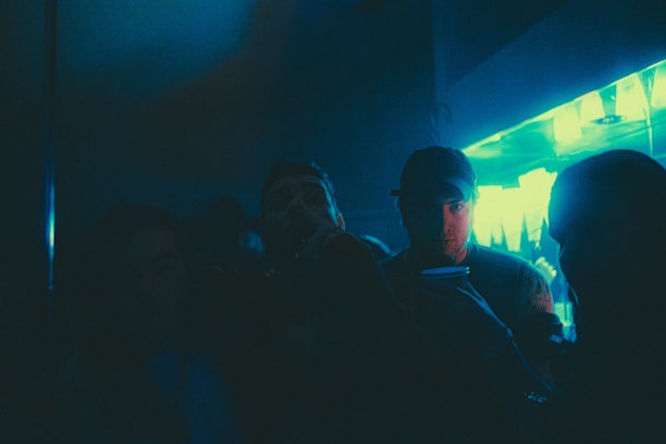 A dark, futuristic club scene with blue and white lights.