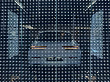 High-tech car electronics display glowing softly in a dark garage setting