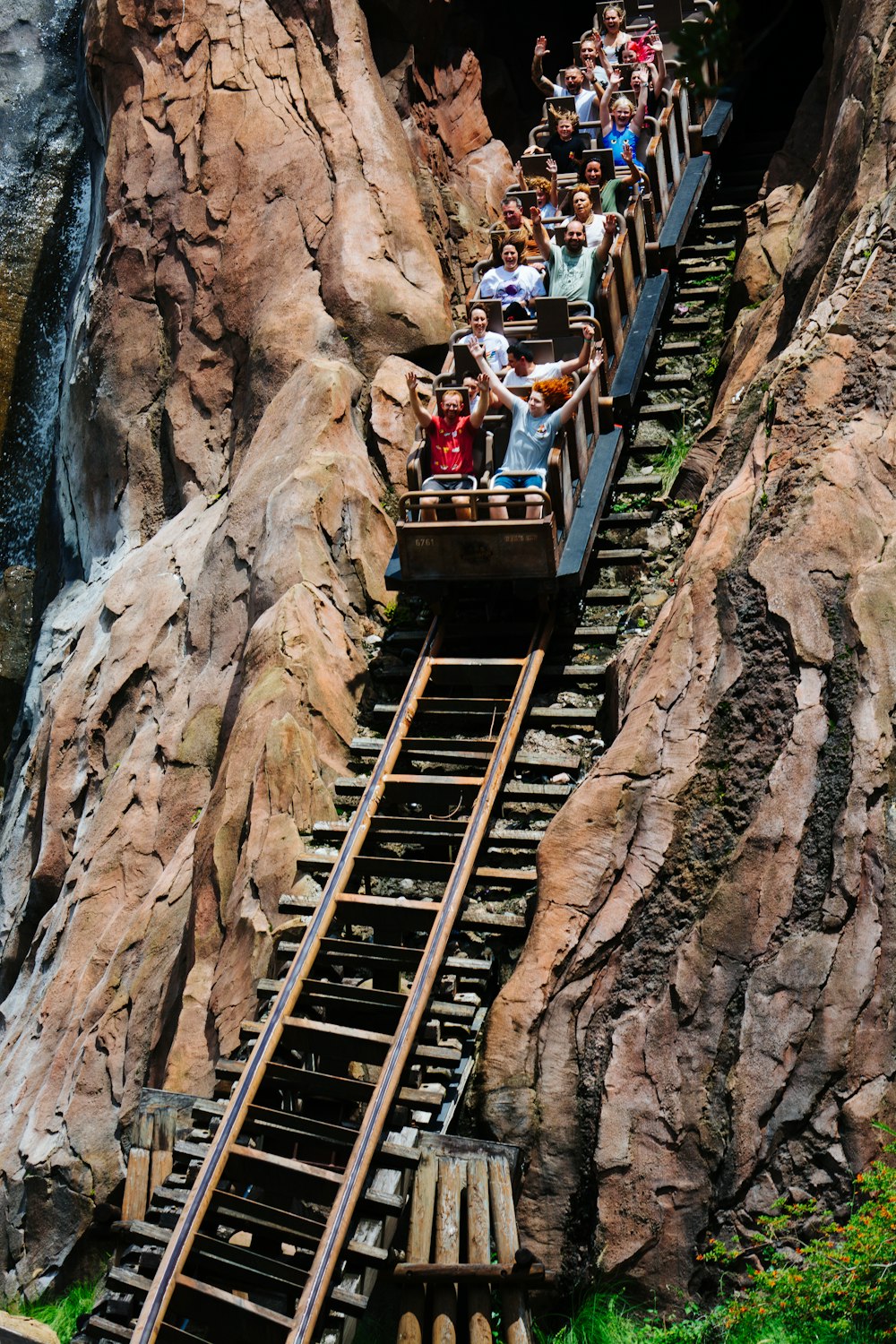 a group of people riding a roller coaster down a mountain
