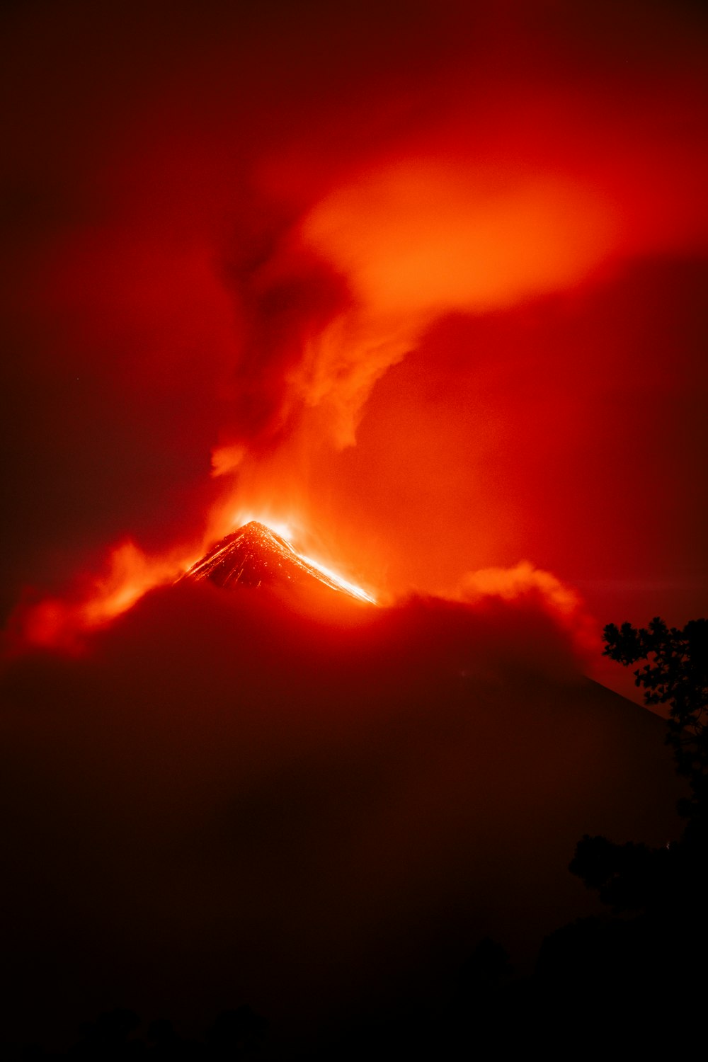 a red and black photo of a volcano