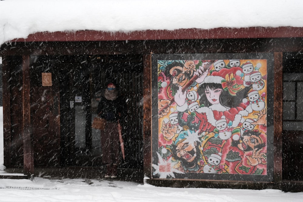 a man standing in front of a painting in the snow