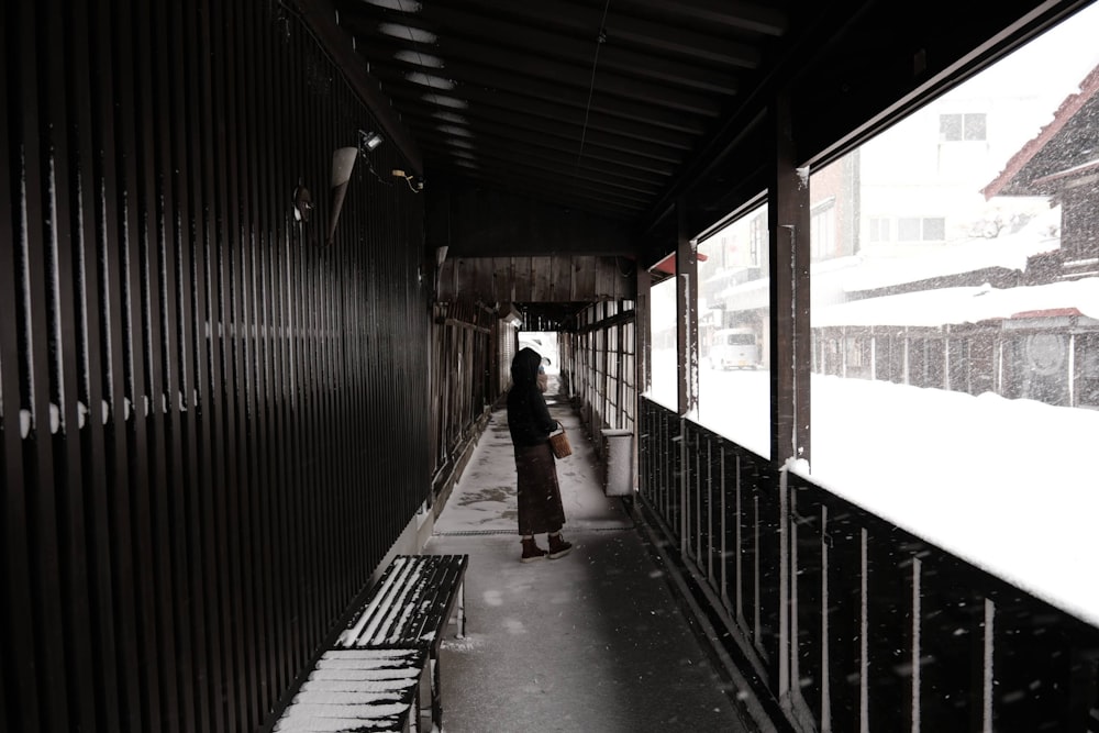 a person walking down a walkway in the snow