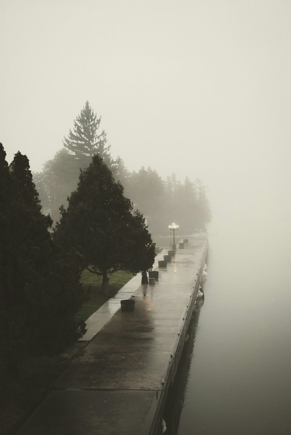 people walking down a sidewalk in the rain