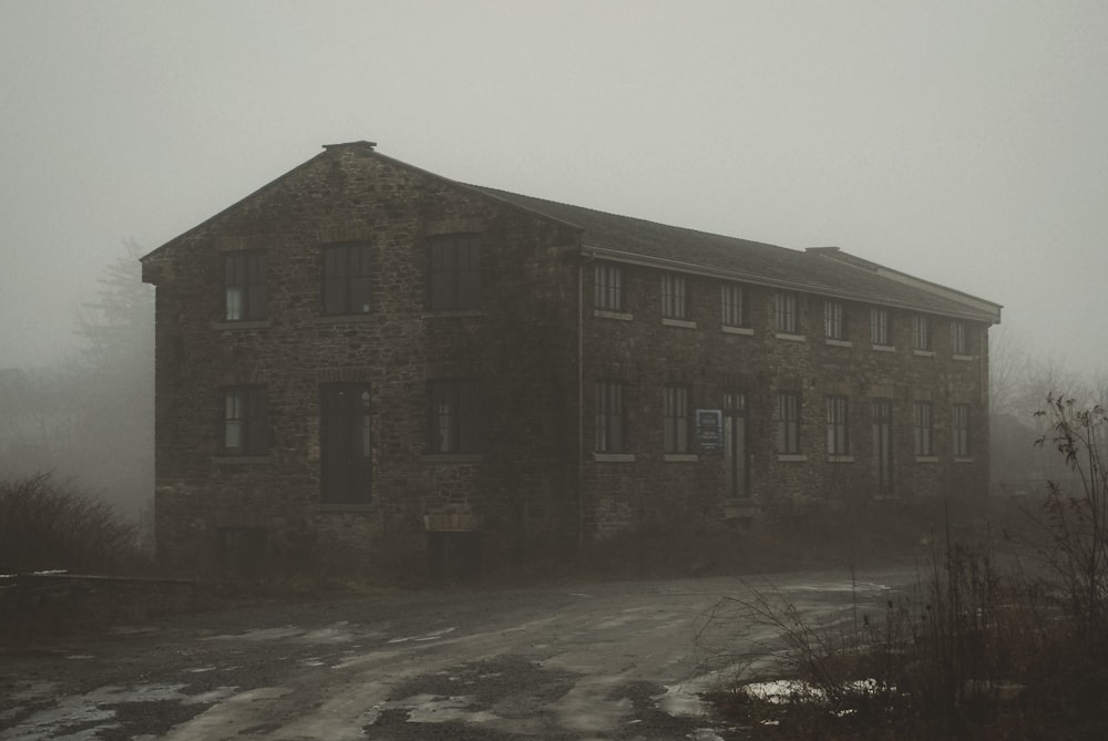 an old brick building on a foggy day