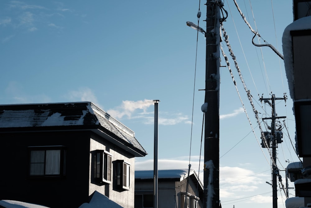 a telephone pole and some buildings in the snow